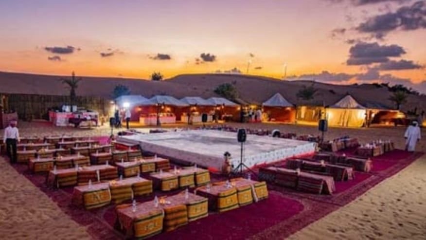 Desert camp event setup at sunset